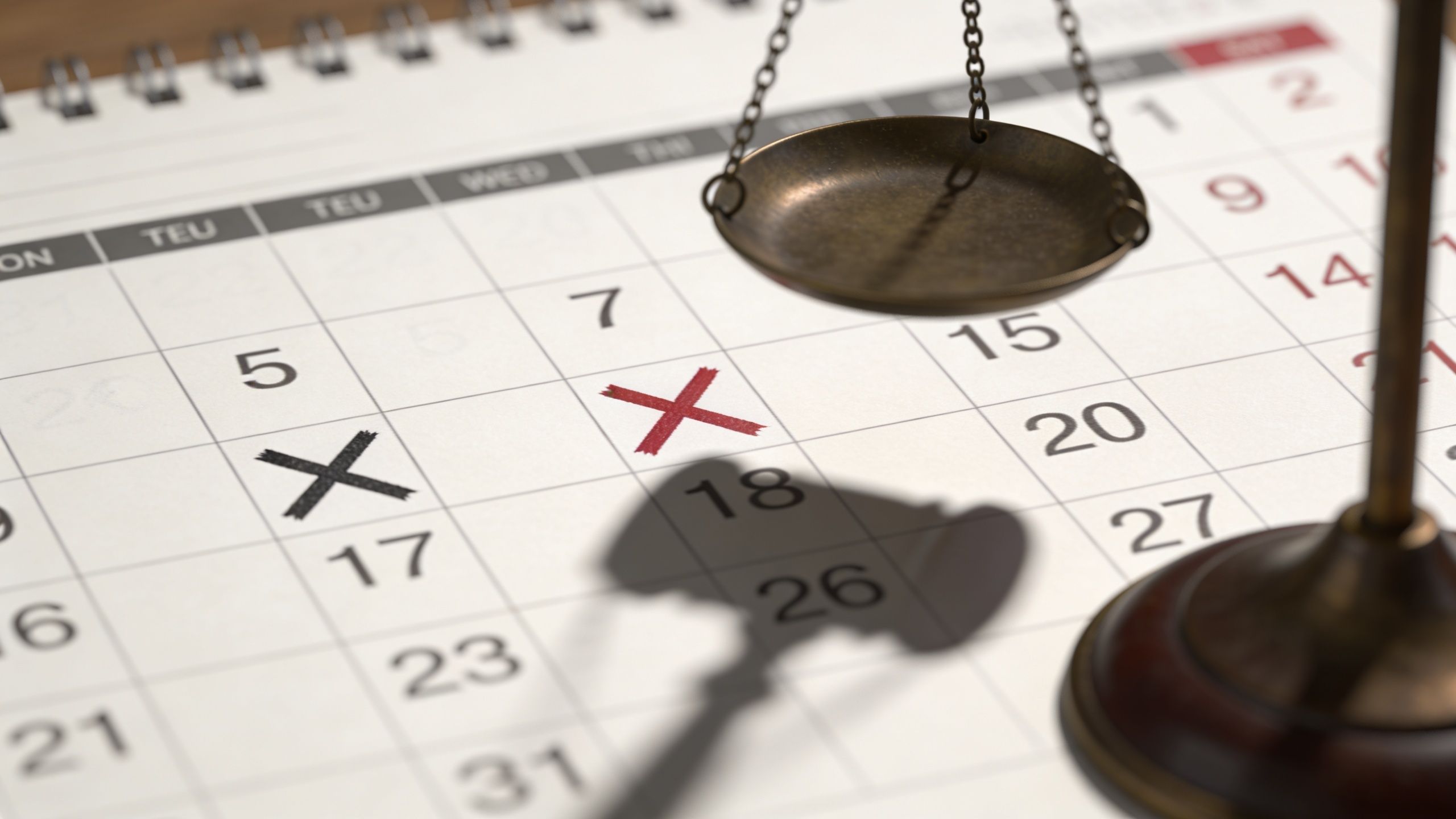 A legal scale and gavel shadow over a calendar with marked dates symbolizing court appointments.